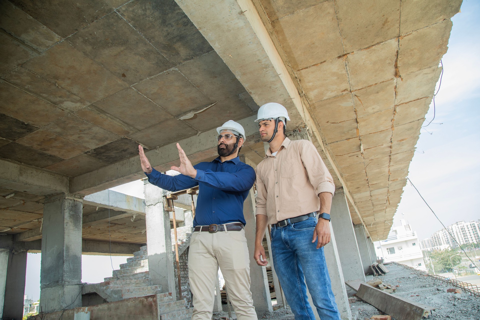 Male contractors discussing project at construction site